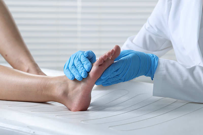 A vascular doctor checking a patient's feet
