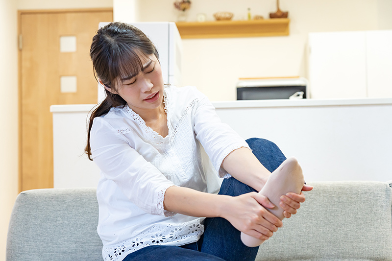 A woman experiencing pain from poor blood circulation