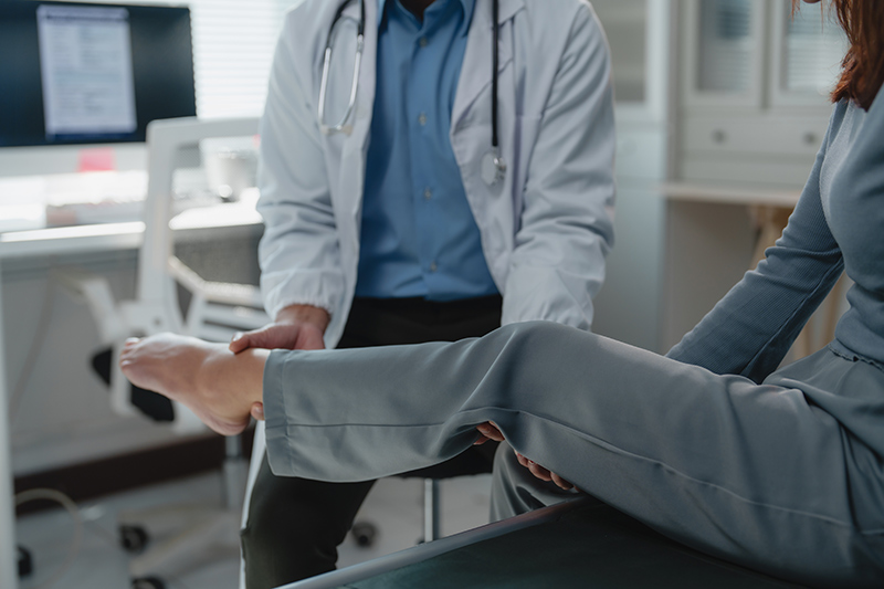 A doctor checking a patient's legs