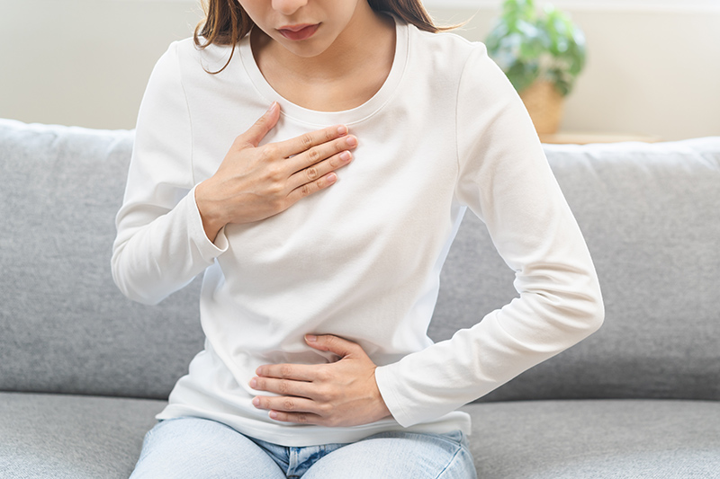 Woman experiencing chest discomfort.